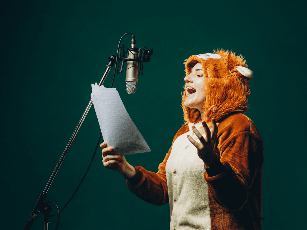 A lady recording in studio for voice over work using a condenser microphone