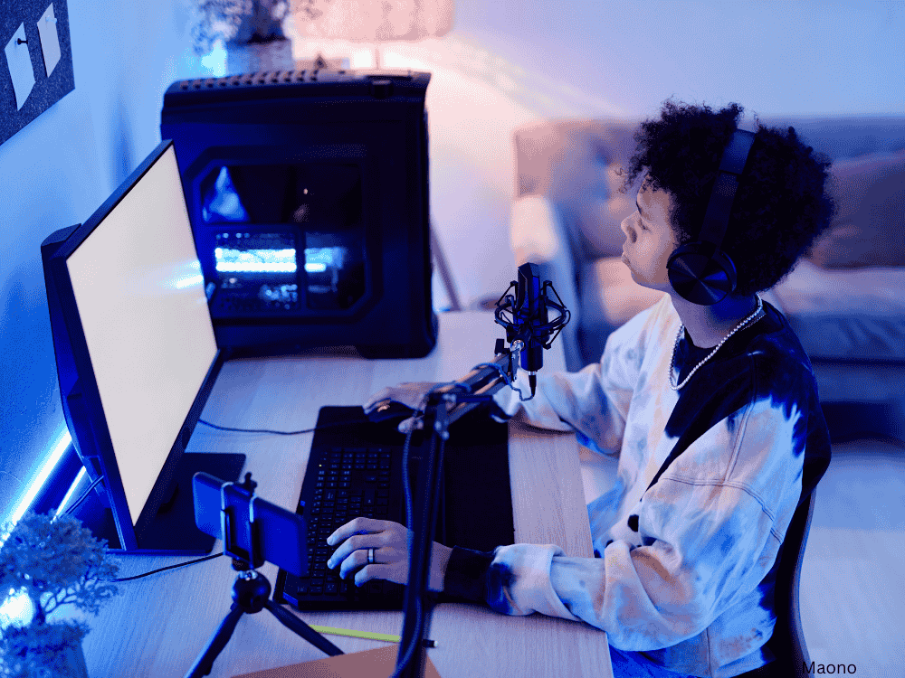 A child playing video games while live streaming using a USB microphone