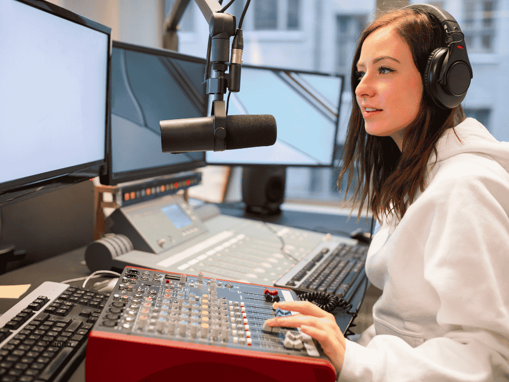 A female podcaster using an audio mixer and XLR microphone during her stream