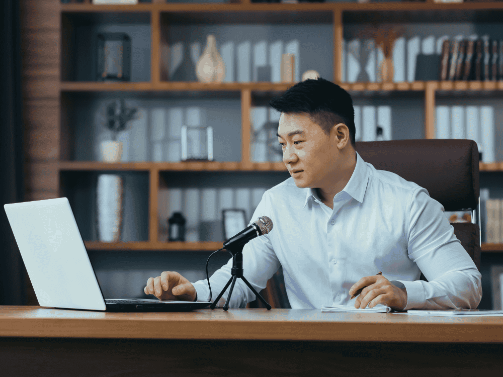 A male businessman during a conference call using a USB microphone