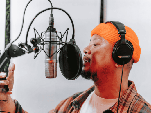 A man recording using a USB condenser microphone for singing