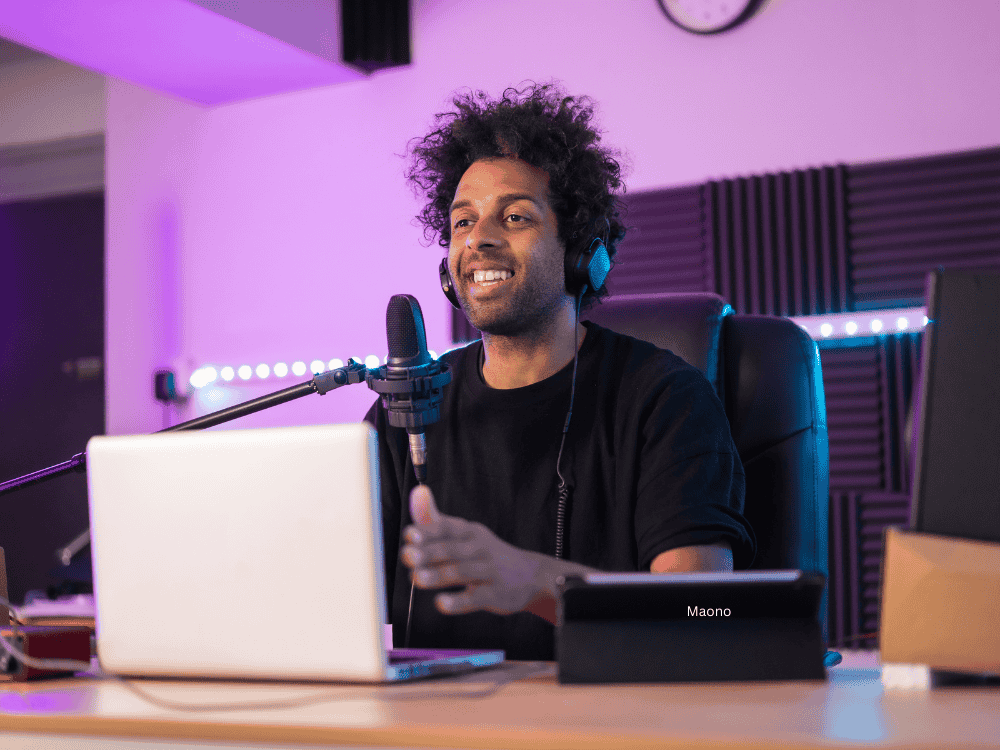 A male vlogger using an XLR condenser microphone during stream