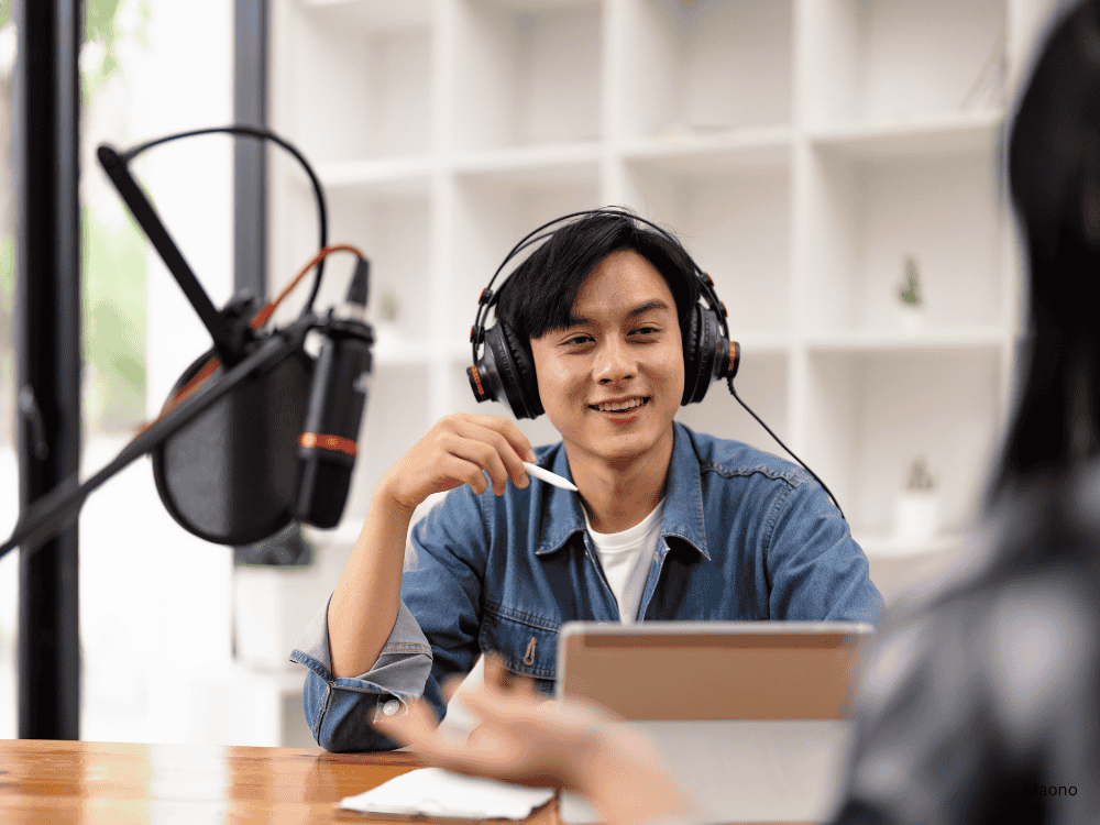 A male podcaster using a cardioid microphone