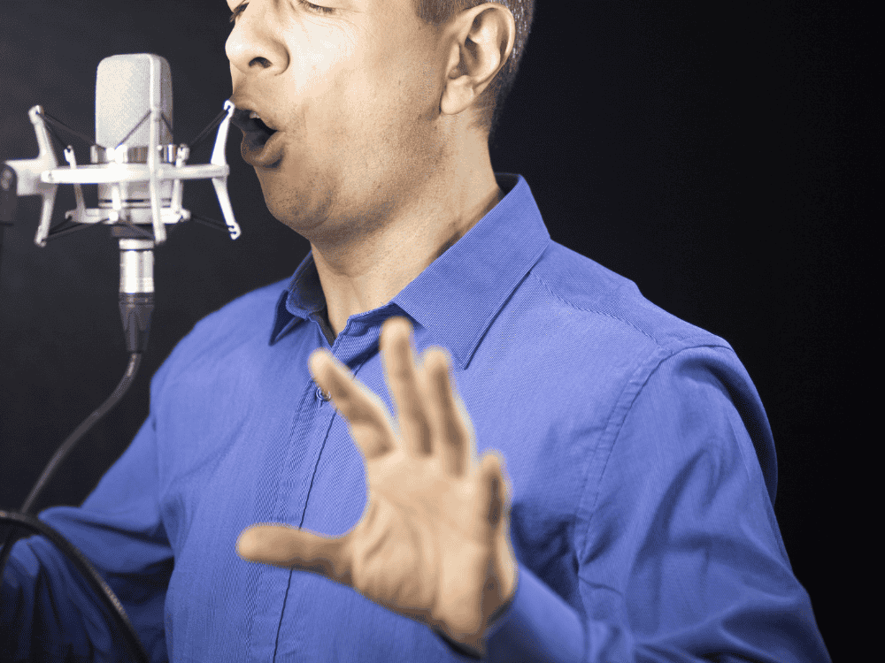 A male voice artist using a voice over mic