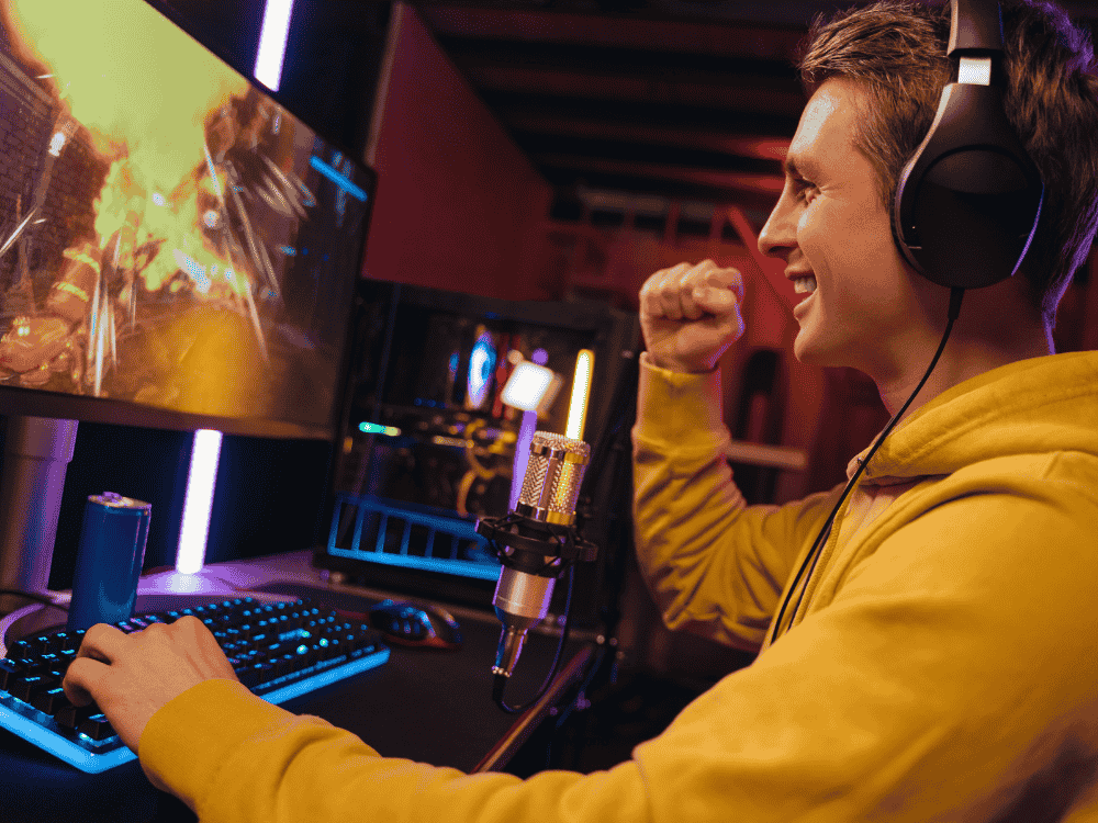 A male gamer using a cardioid microphone while streaming