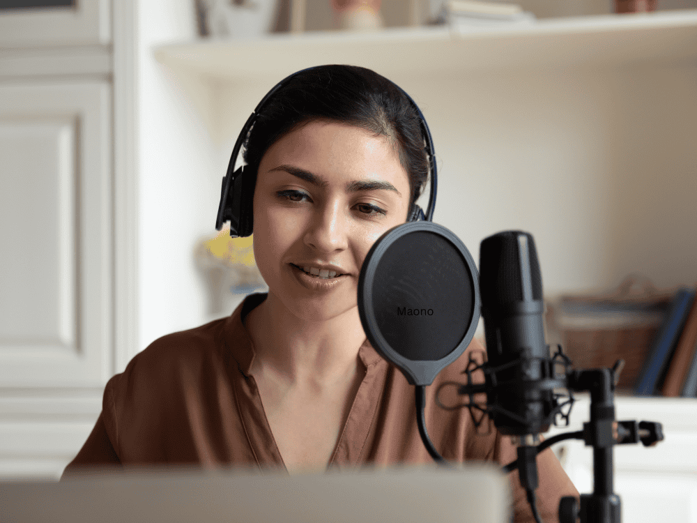 A female using a recording mic for voice acting work