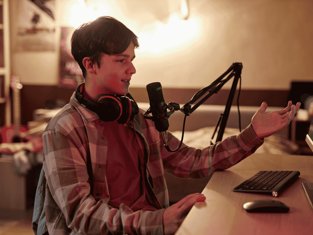 A boy streaming video games in YouTube using a dynamic microphone