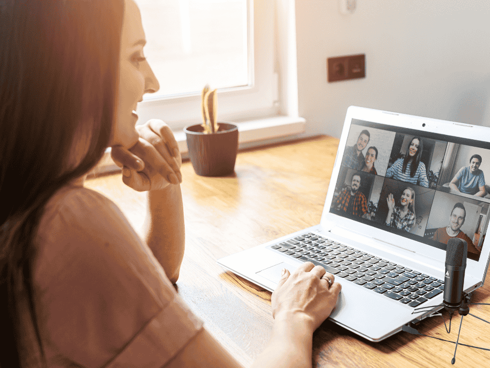 A lady using a condenser USB microphone while in Zoom meeting