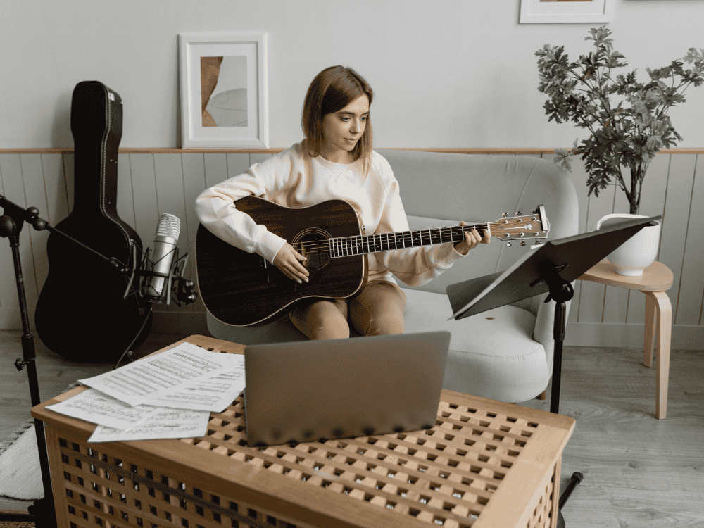 A musician recording acoustic guitar using a dynamic microphone USB/XLR