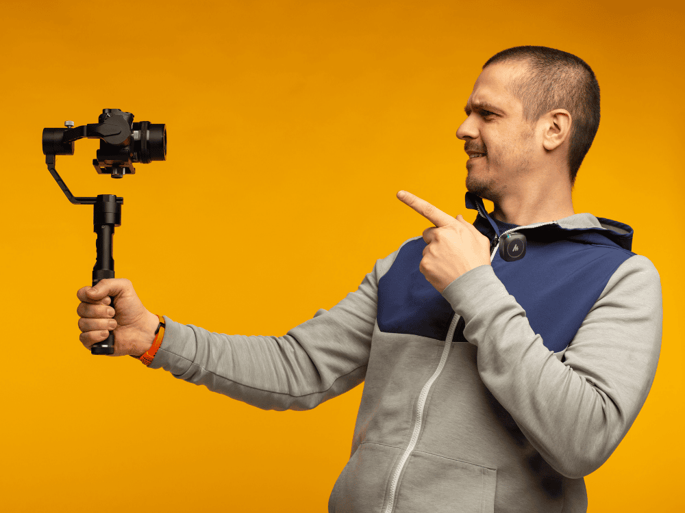 A content creator recording a vlog using a camera and wireless lapel microphone