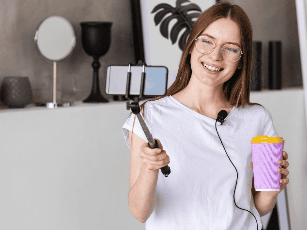 A female content creator recording a vlog using a wired lapel mic