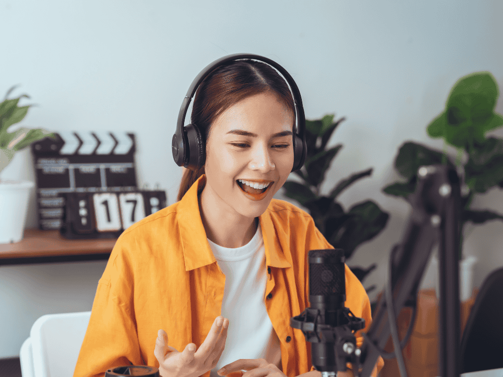 A female podcaster doing a live podcast using a podcast microphone