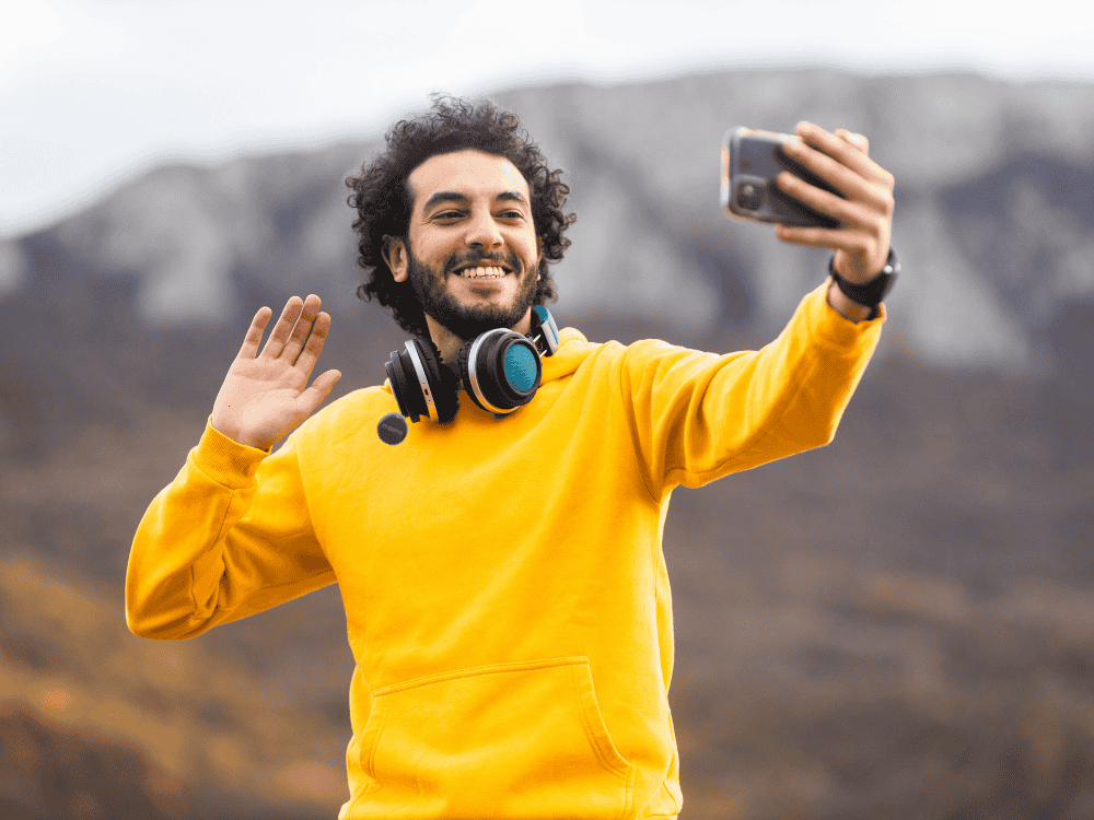 A male travel vlogger recording his vlog using a wireless microphone