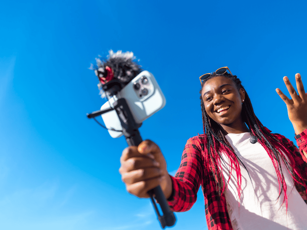 A female travel vloggers using a Maono T5 wireless microphone