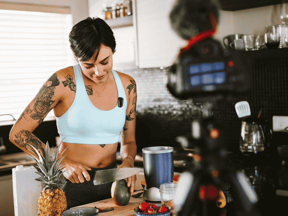 A female vloggers using Maono Wave T1 Mini wireless microphone while filming her cooking show