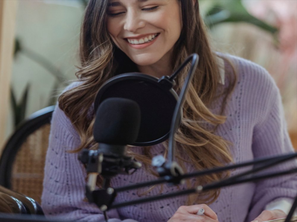 woman using a podcasting microphone