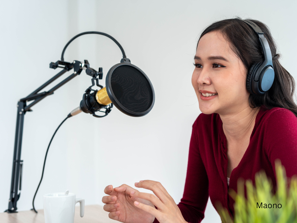 a female podcasting using a microphone and a boom mic arm