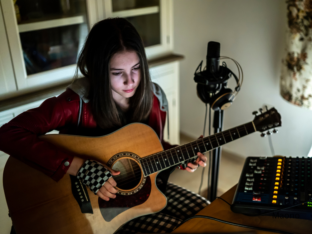 a girl music live streaming at home using an audio interface or audio mixer