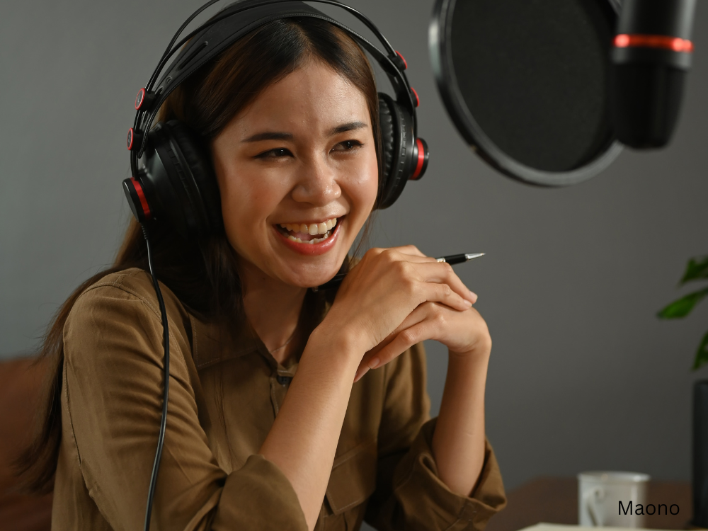 a lady recording a podcast using a podcast soundproof kit