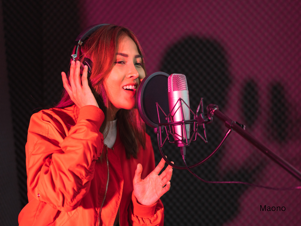 a lady singing in studio using a condenser microphone