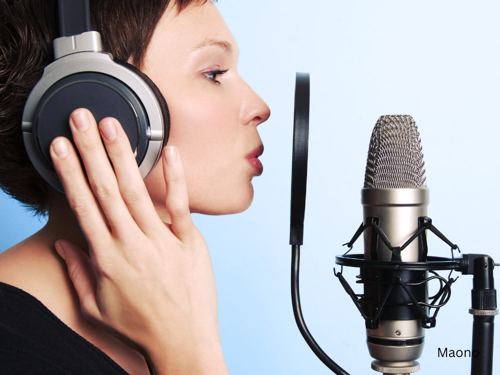 vocalist singing in studio using a pop filter for mic