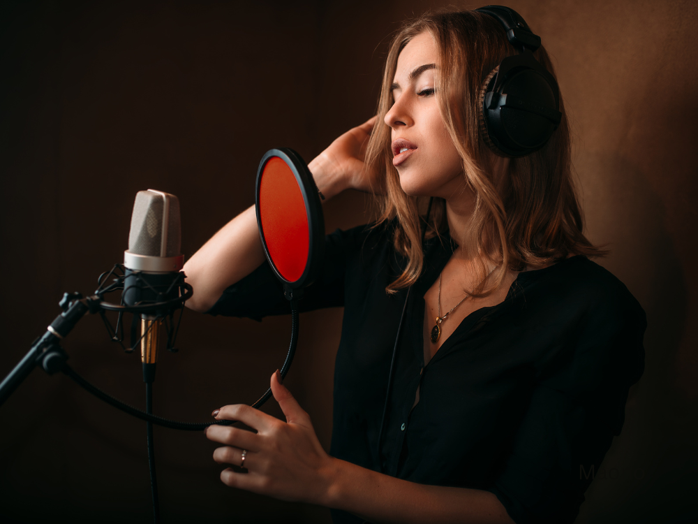 female singing using a recording microphone