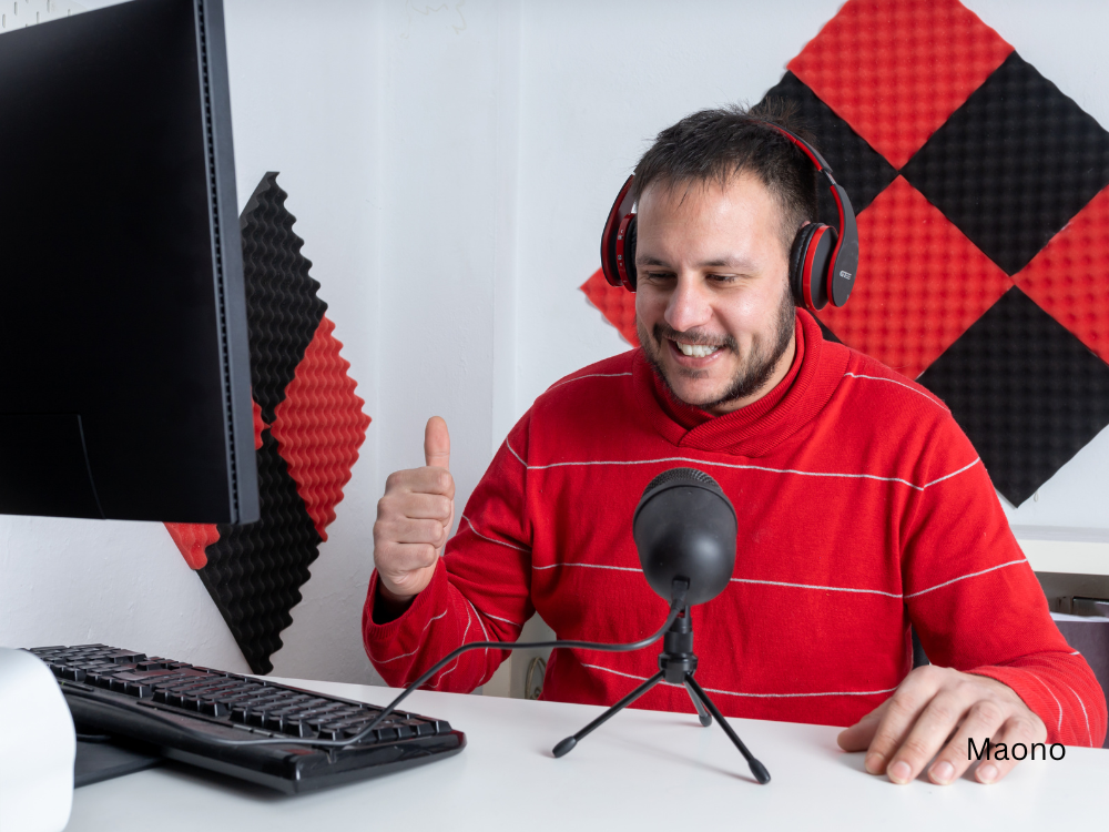 male recording a podcast using a mic and a microphone stand