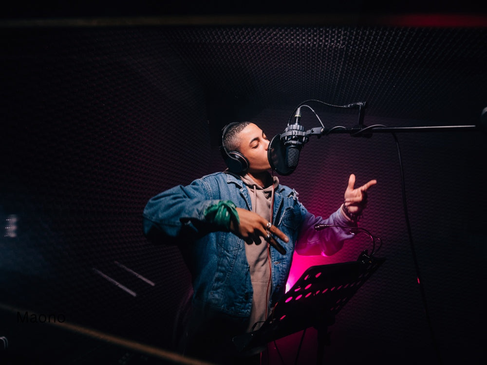 man singing in a studio using a good USB condenser mic