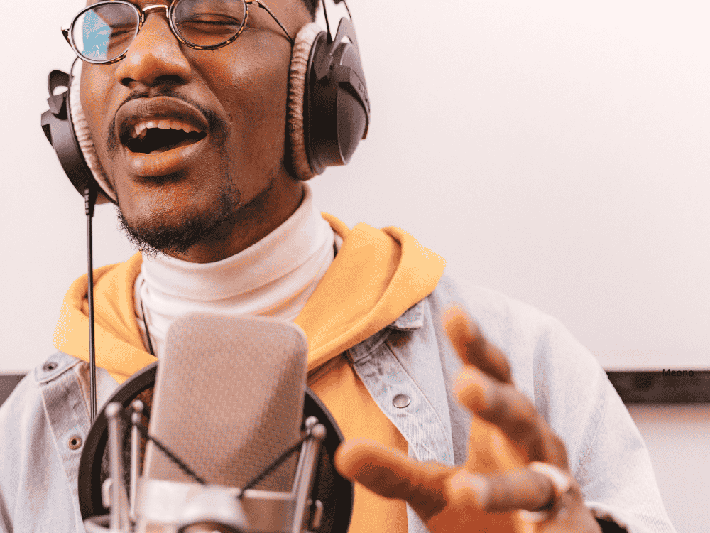  A male musician recording in studio using a condenser singing microphone