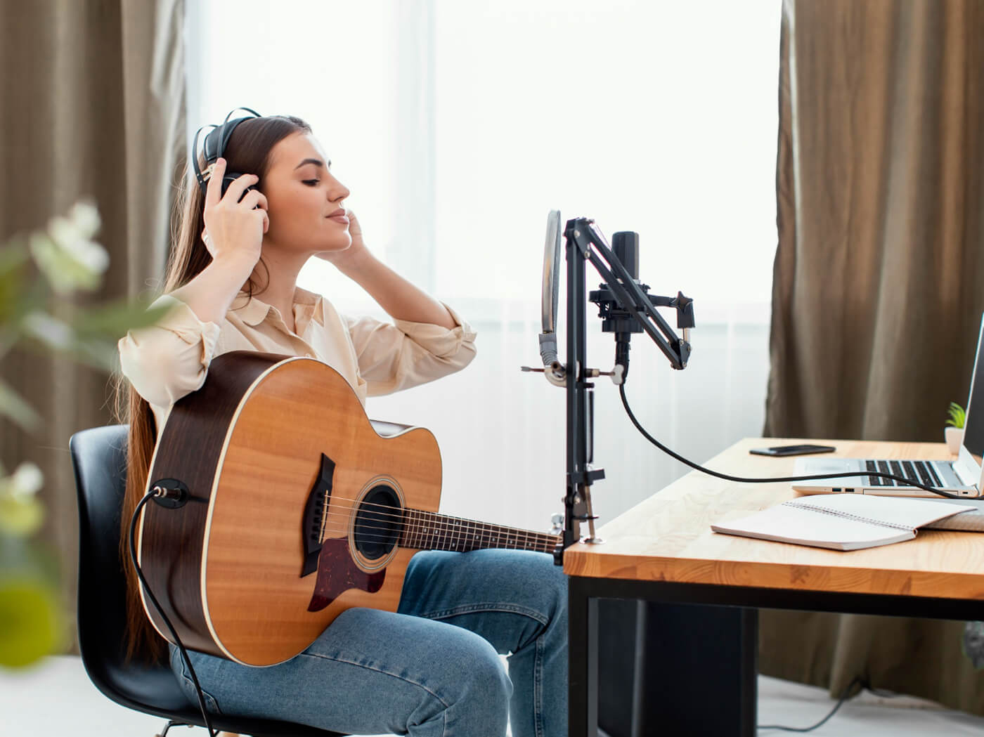 A woman practicing recording vocals at home