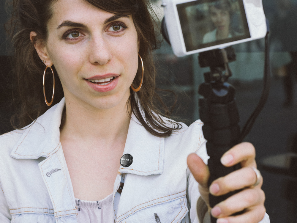 woman vlogging outdoors using a Lavalier USB C microphone